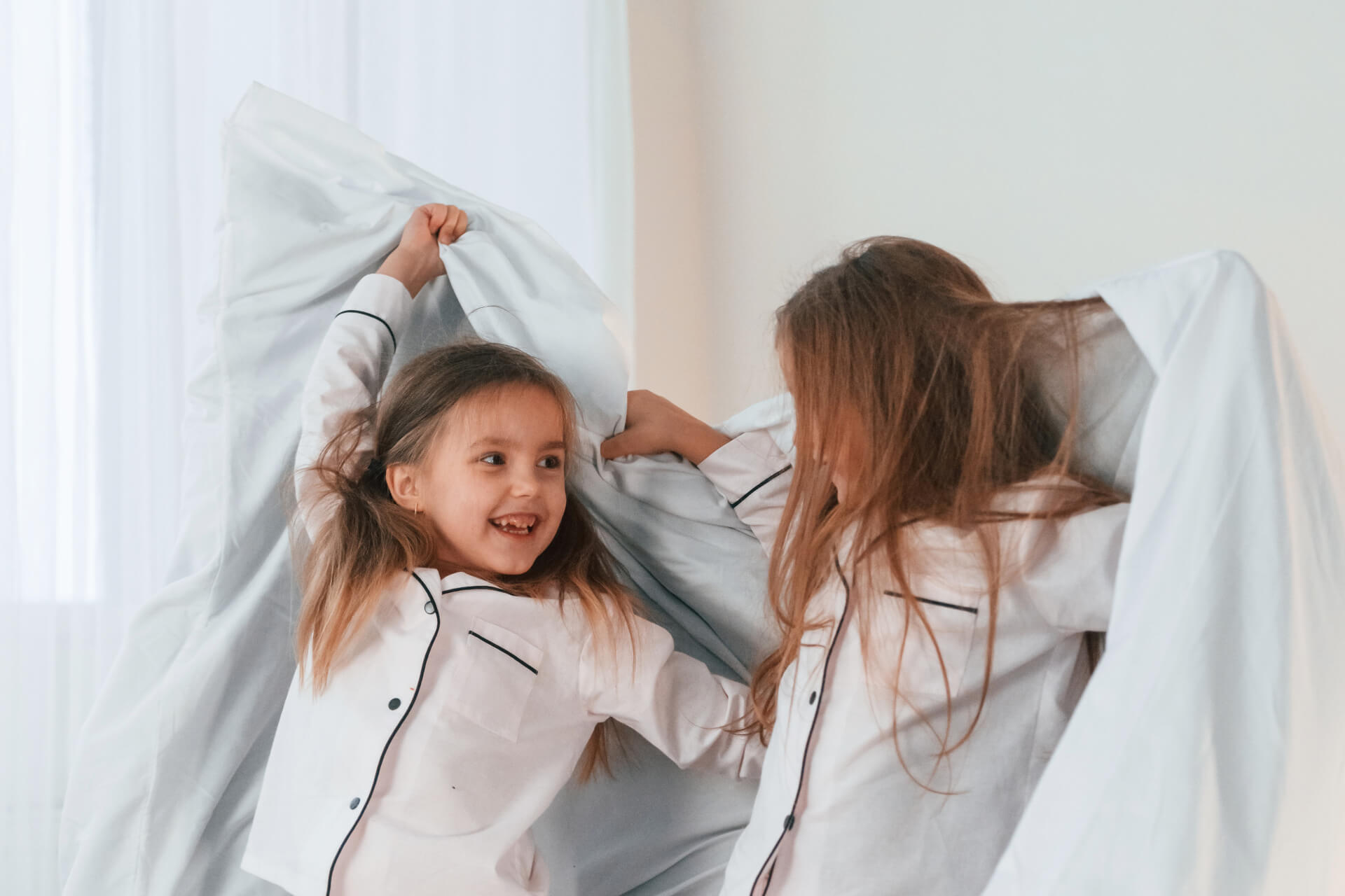 Dzieci bawiące się razem na łóżku