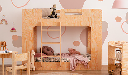 Drewniane łóżko piętrowe wykonane ze sklejki sosnowej w kolorze lakierowanego drewna z drabinką po lewej stronie